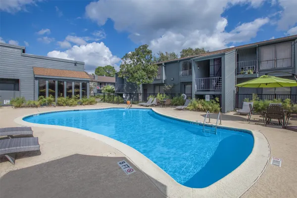 a view of a house with swimming pool and sitting area