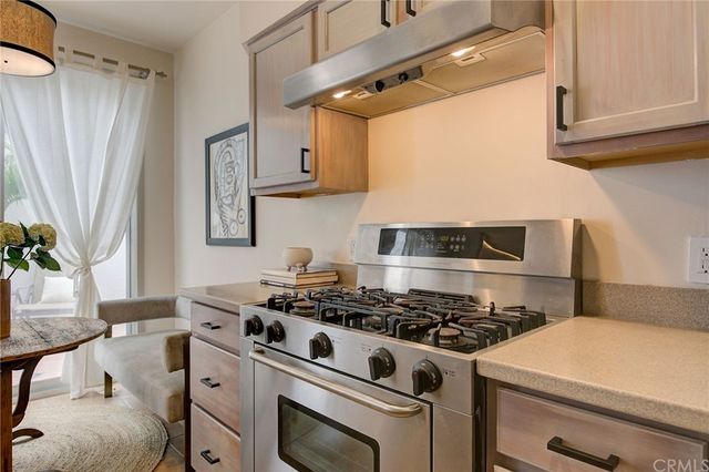 a white stove top oven sitting inside of a kitchen