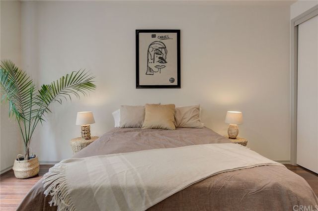 a bedroom with a bed and a potted plant