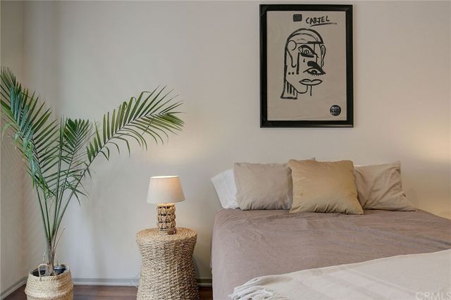 a bedroom with a bed and a potted plant