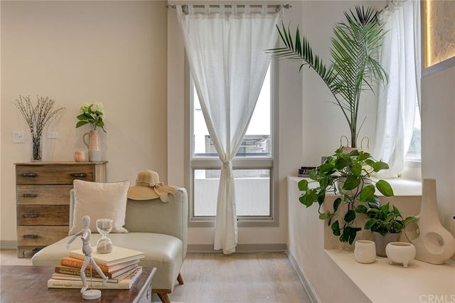 a view of a dining room with furniture and a potted plant
