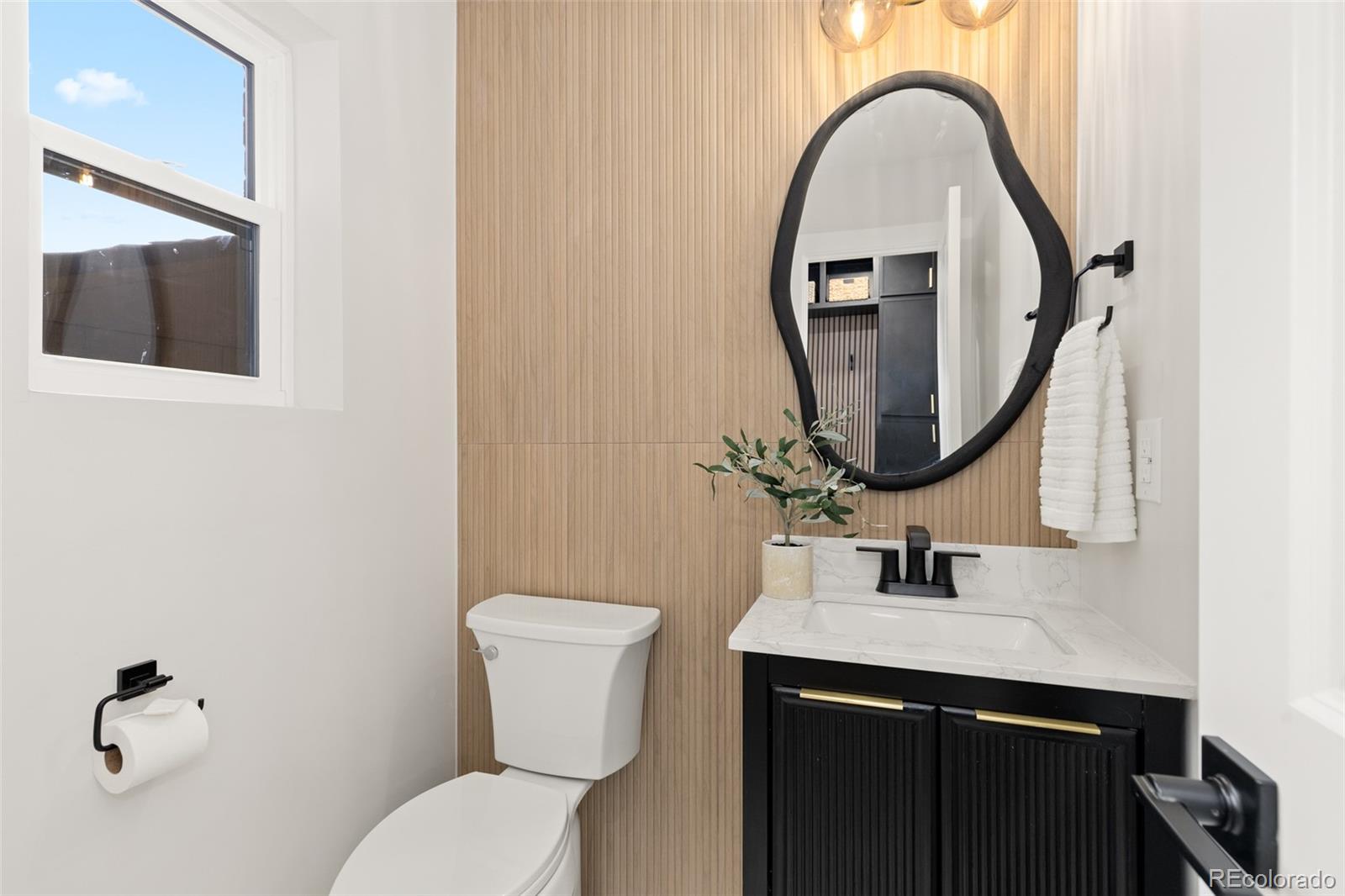 11895 West 35th Avenue Wheat Ridge, CO 80033 - Photo 18 of 50 a bathroom with a toilet sink and mirror