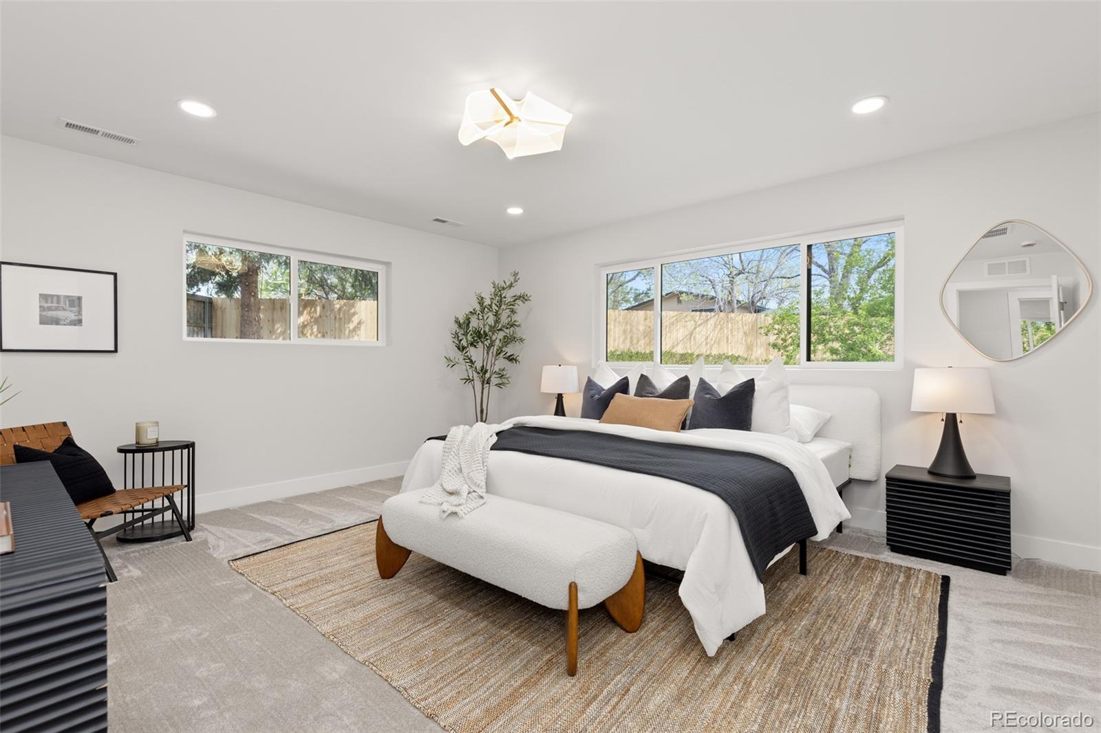 11895 West 35th Avenue Wheat Ridge, CO 80033 - Photo 20 of 50 a spacious bedroom with a bed and a chandelier