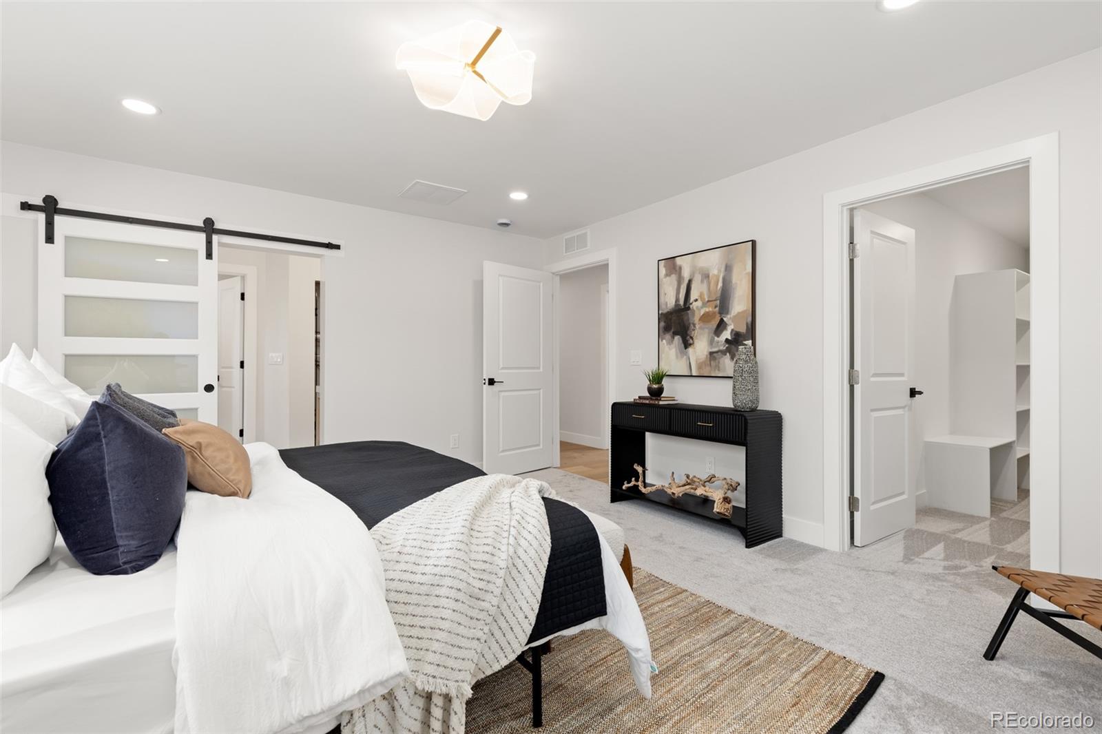 11895 West 35th Avenue Wheat Ridge, CO 80033 - Photo 21 of 50 a bedroom with a bed and a chair