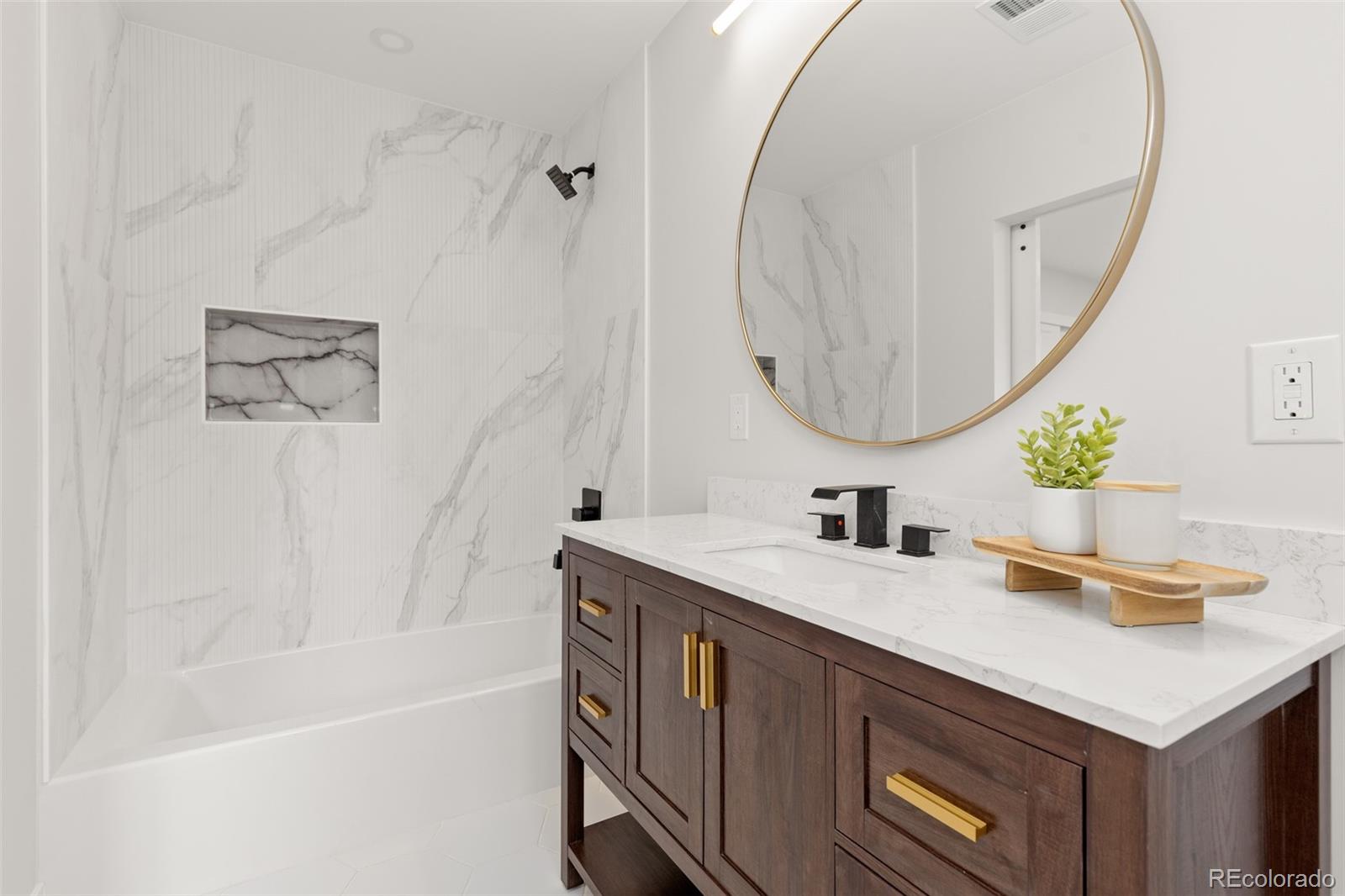 11895 West 35th Avenue Wheat Ridge, CO 80033 - Photo 28 of 50 a bathroom with a sink a vanity and a mirror