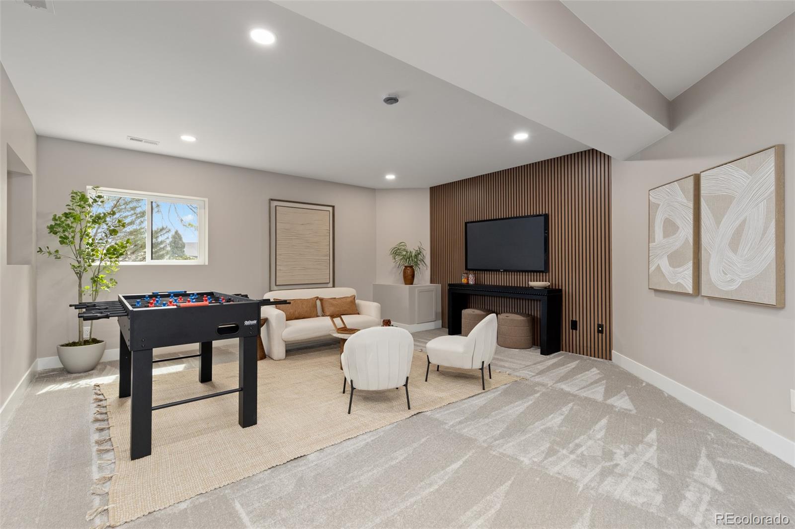 11895 West 35th Avenue Wheat Ridge, CO 80033 - Photo 36 of 50 a living room with furniture and a flat screen tv