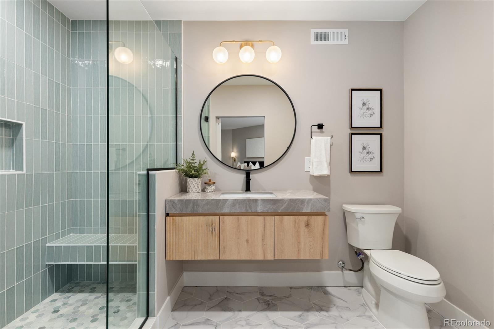 11895 West 35th Avenue Wheat Ridge, CO 80033 - Photo 39 of 50 a bathroom with a toilet a sink and mirror