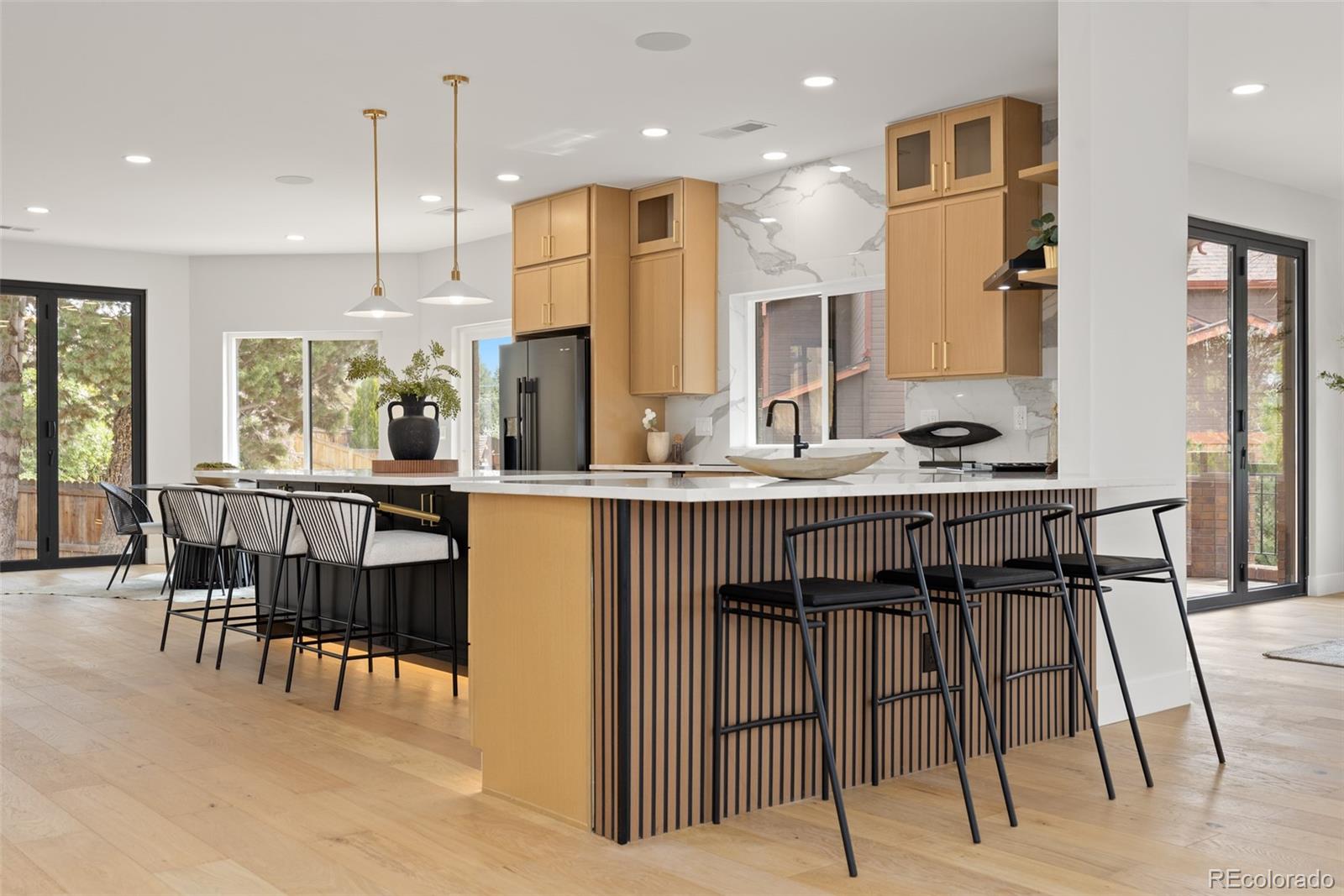 11895 West 35th Avenue Wheat Ridge, CO 80033 - Photo 5 of 50 a kitchen with kitchen island granite countertop a table and chairs in it