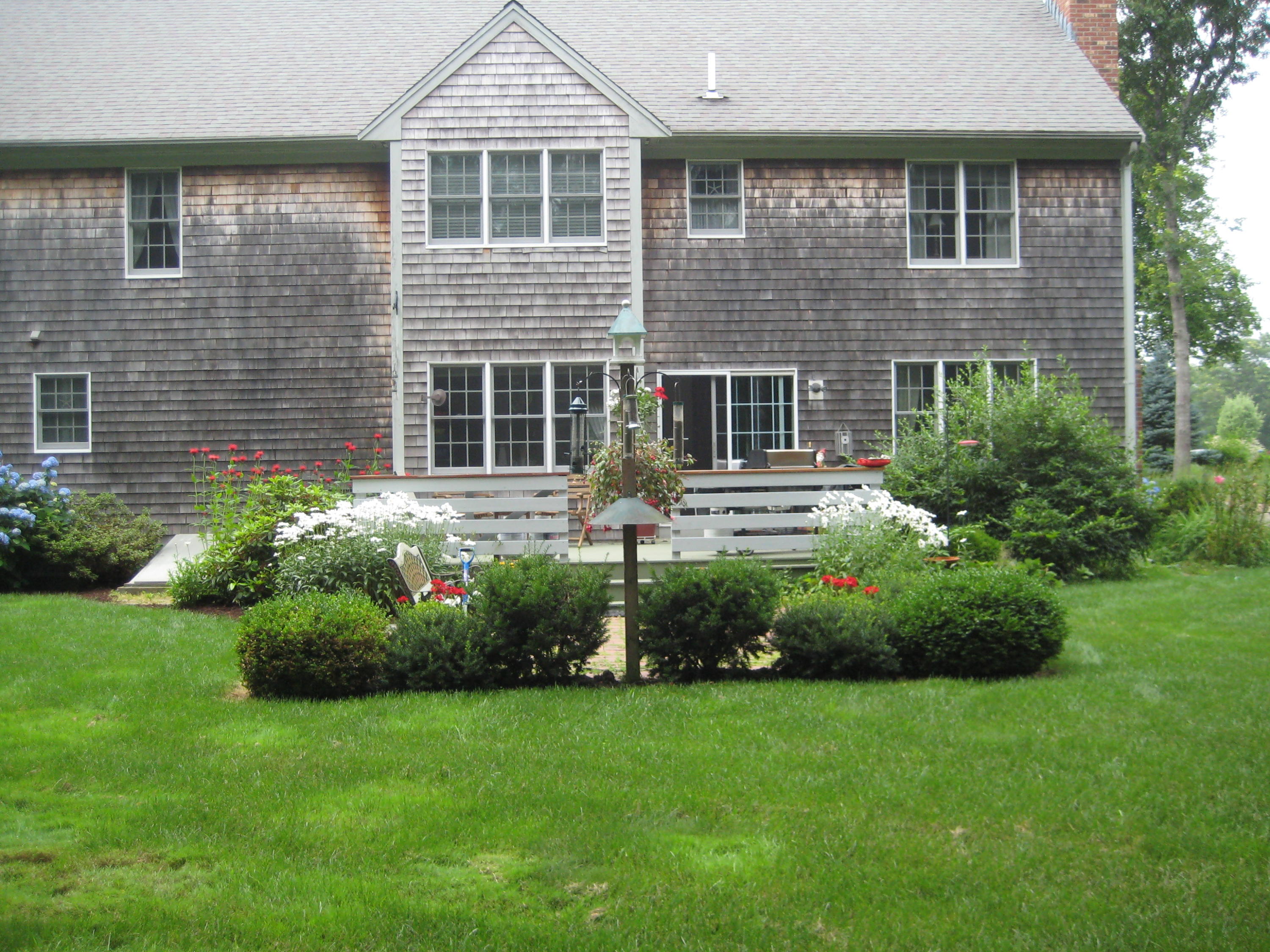 2 Tiffany Road Monument Beach, MA 02532 - Photo 17 of 35 a front view of a house with garden
