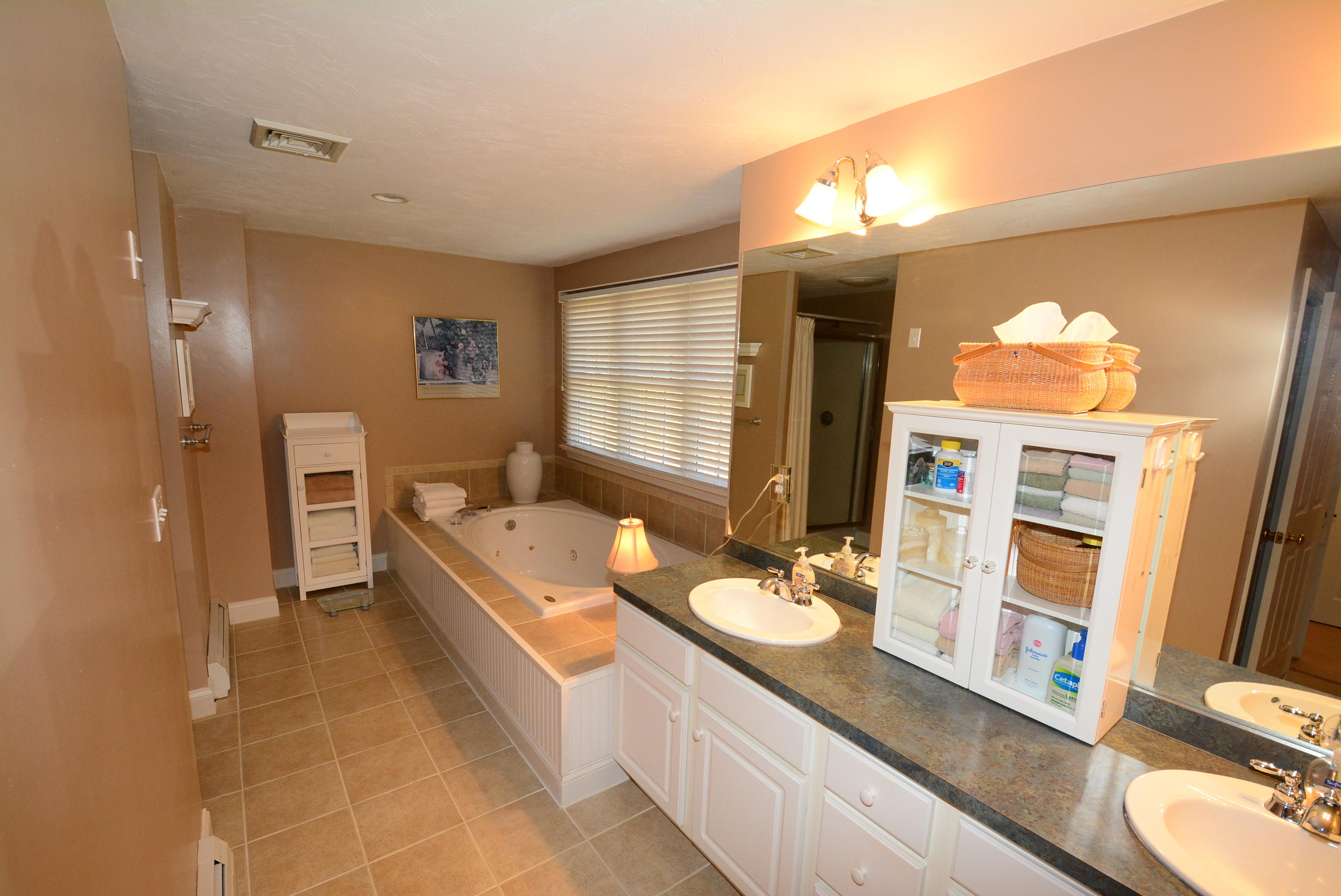 2 Tiffany Road Monument Beach, MA 02532 - Photo 30 of 35 a bathroom with a granite countertop double vanity sink a mirror and a bathtub