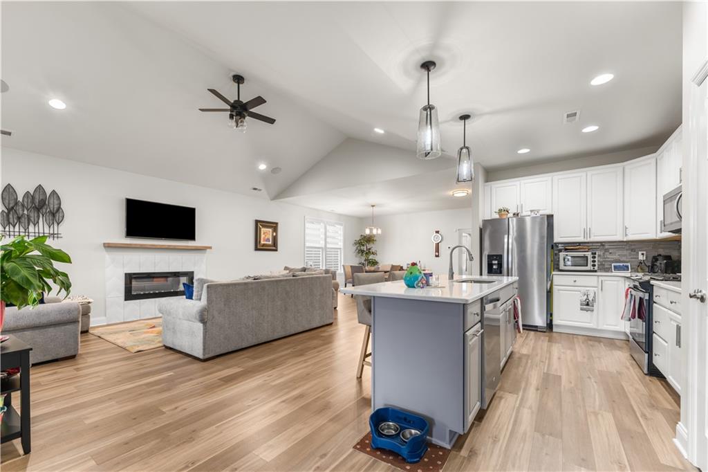 317 Anthem Way Canonsburg, PA 15317 - Photo 6 of 50 a living room with kitchen island furniture and a flat screen tv