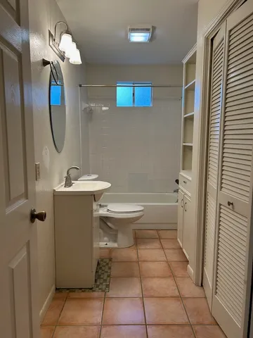 a view of a livingroom with a ceiling fan and window