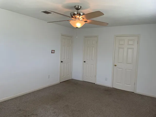 a view of an empty room with windows