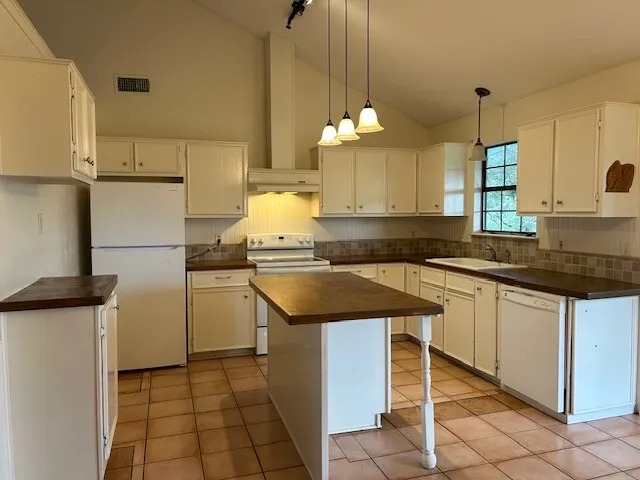 a kitchen with a sink a stove and cabinets