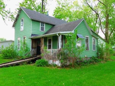 a view of a house with a yard and a garden