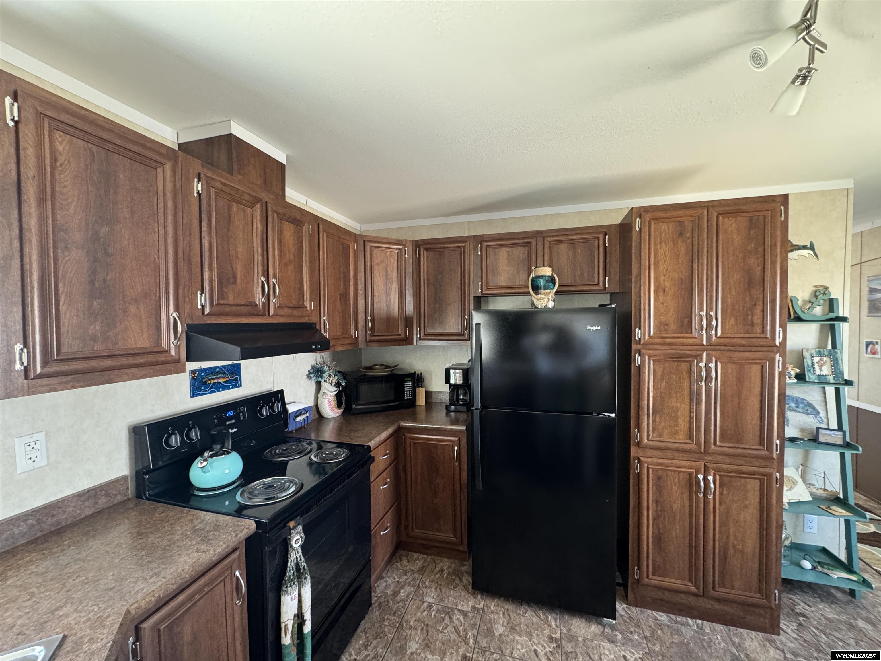 2469 C County Road 351 Sinclair, WY 82334 - Photo 13 of 32 Includes Range, Range hood, Refrigerator, Microwave and Dishwasher. Builtin pantry!