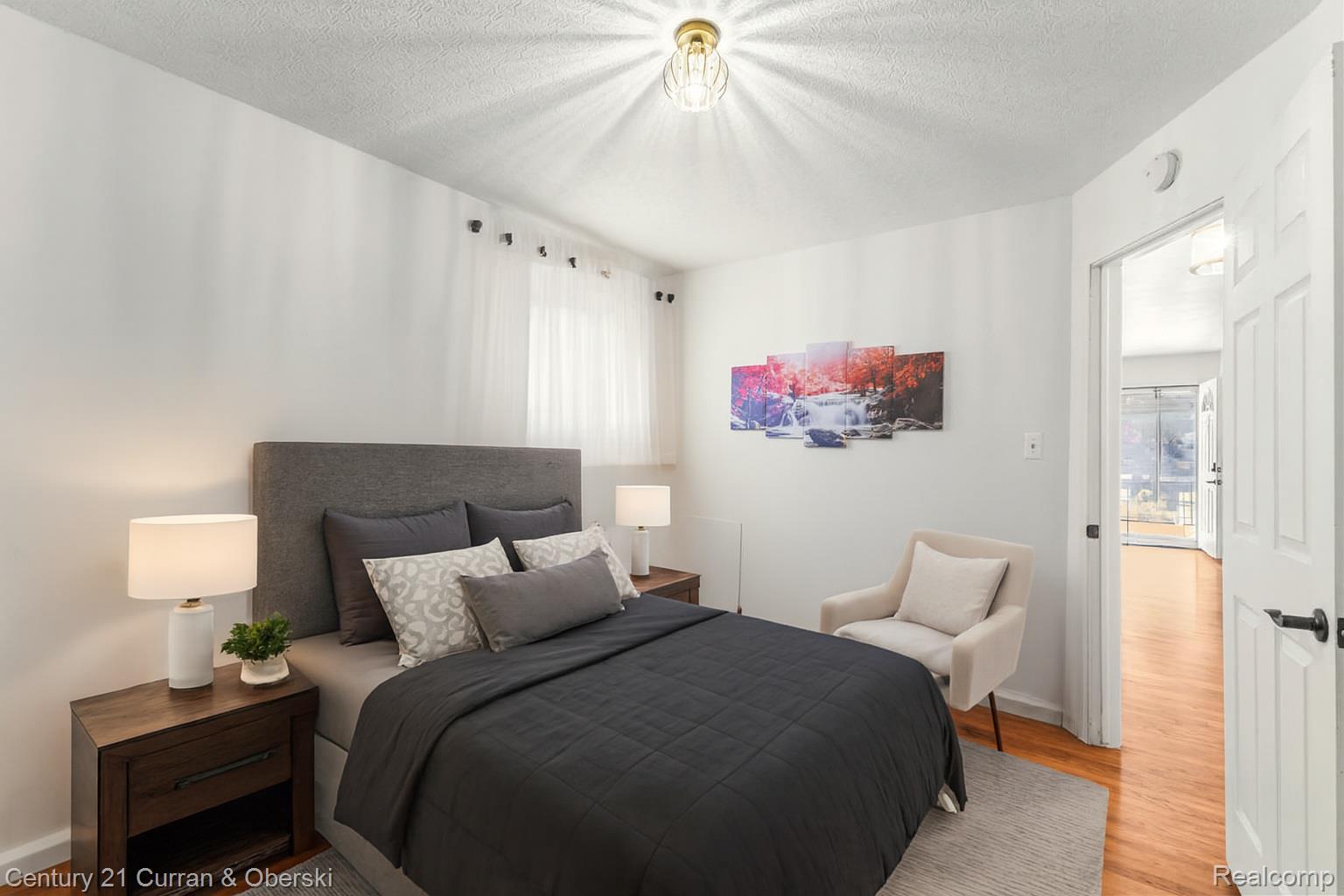22327 Wick Road Taylor, MI 48180 - Photo 6 of 10 Bedroom featuring a textured ceiling and wood finished floors