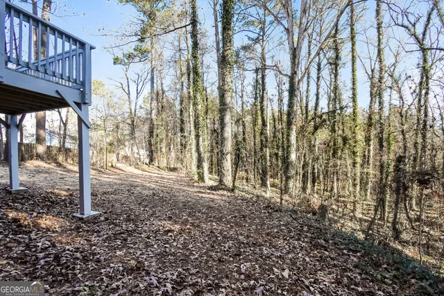 a view of a backyard with large trees