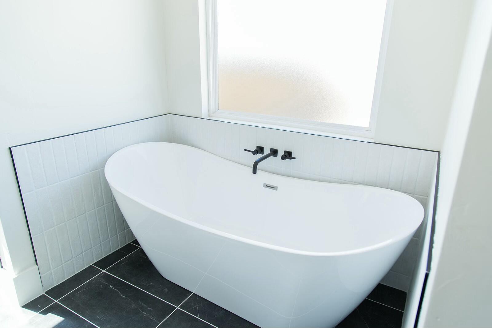 7211 West 12th Street Plainview, TX 79072 - Photo 28 of 48 a white bath tub sitting in a bathroom