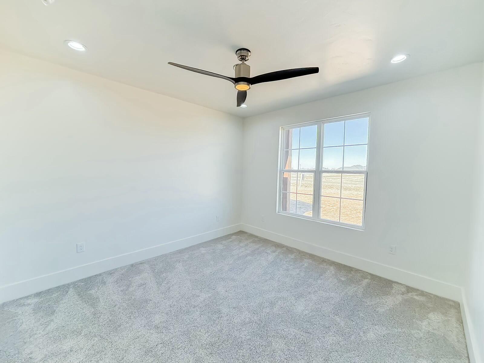 7211 West 12th Street Plainview, TX 79072 - Photo 33 of 48 an empty room with a ceiling fan and window