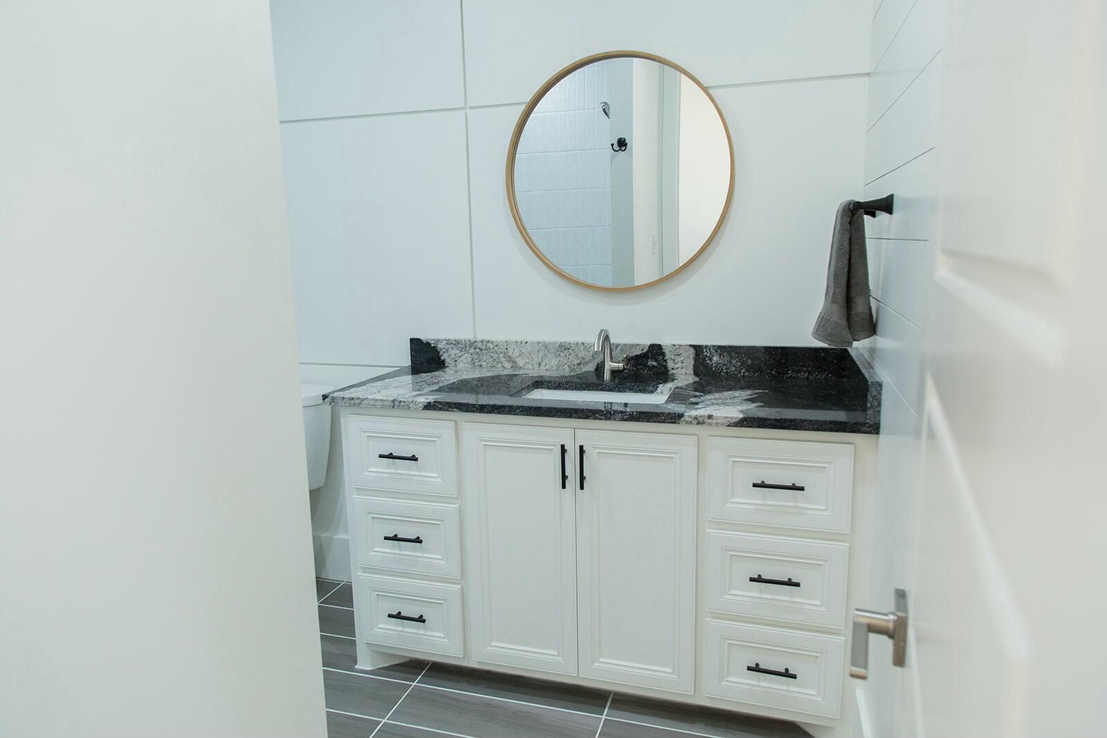 7211 West 12th Street Plainview, TX 79072 - Photo 35 of 48 a bathroom with a sink and a mirror