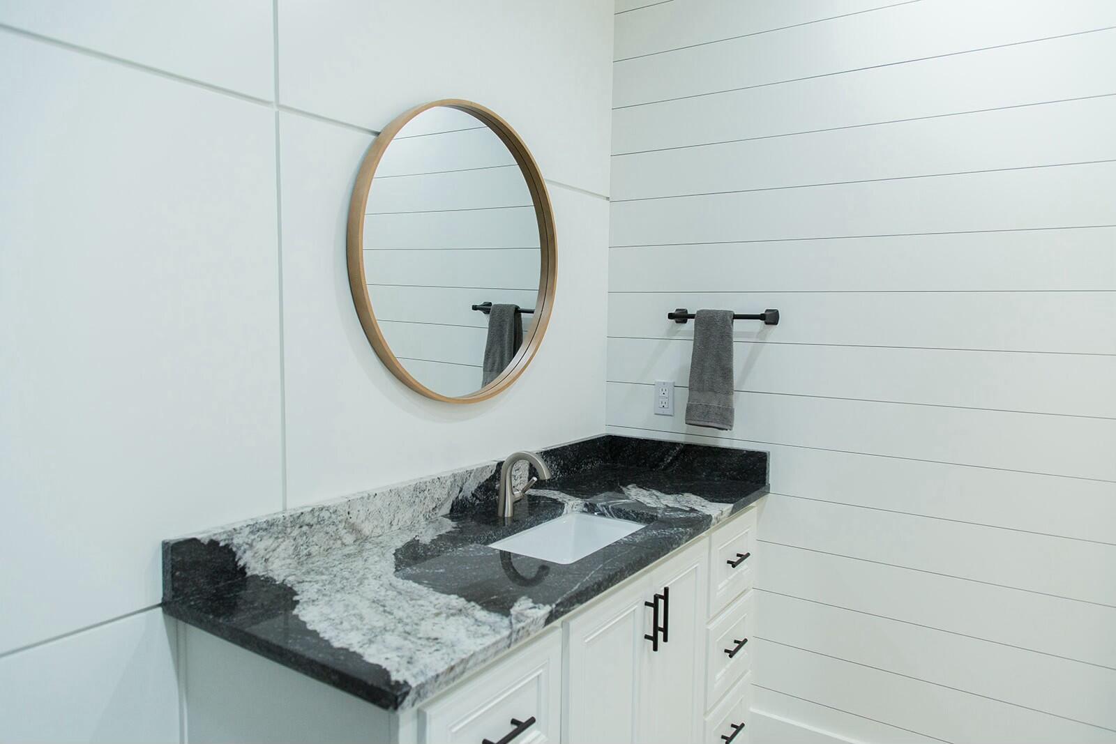 7211 West 12th Street Plainview, TX 79072 - Photo 36 of 48 a bathroom with a sink and a mirror