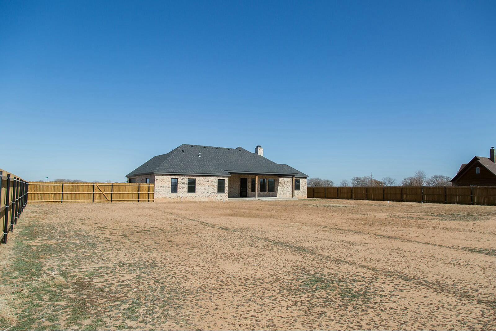 7211 West 12th Street Plainview, TX 79072 - Photo 43 of 48 a big house with a big yard and large trees