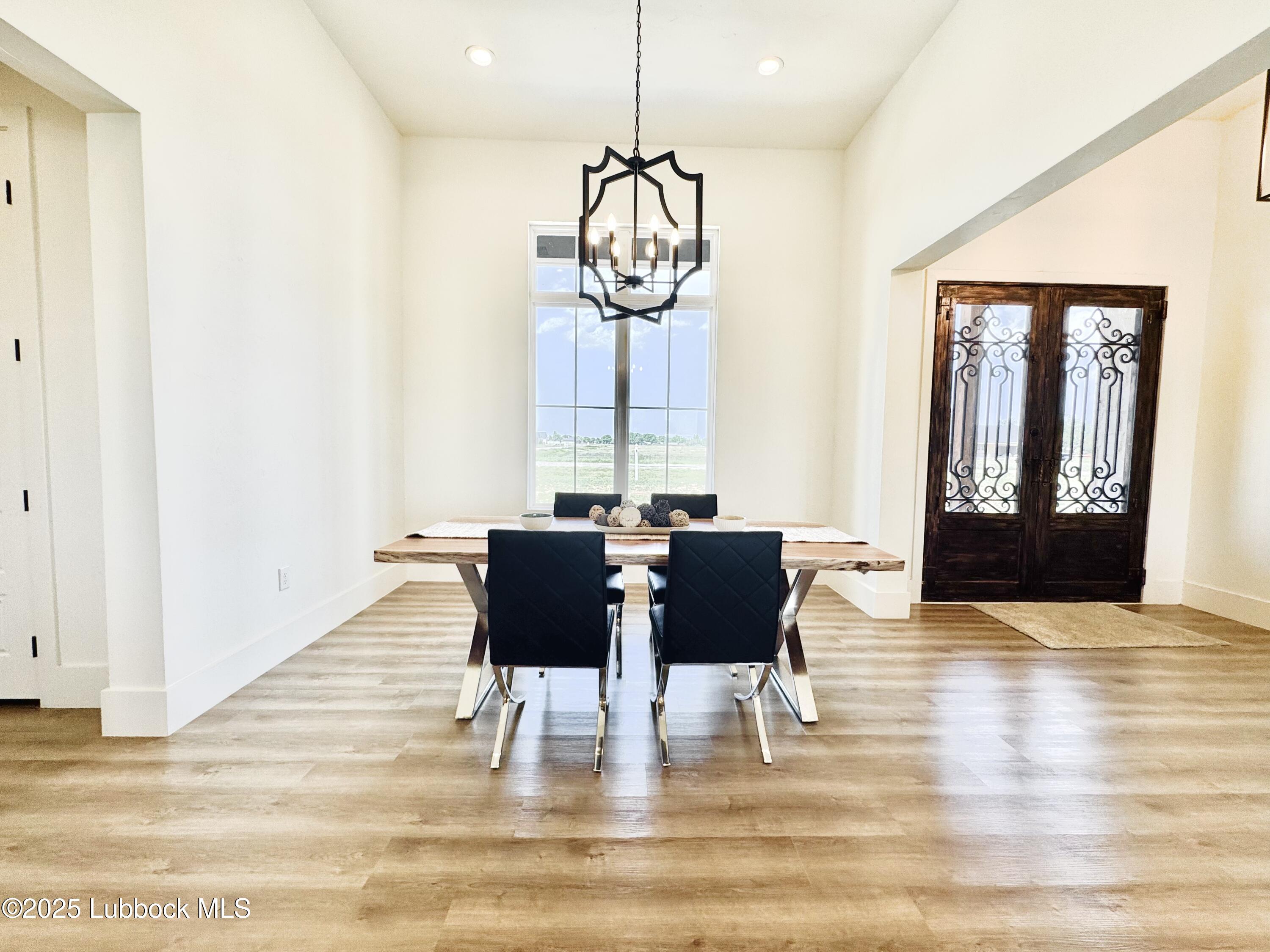 7211 West 12th Street Plainview, TX 79072 - Photo 8 of 48 a view of a dining room with furniture window and wooden floor