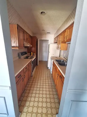 a kitchen with sink a stove and refrigerator