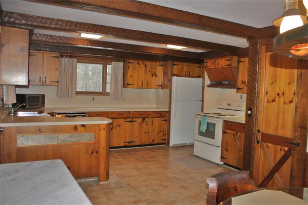 445 Falmouth Road Barnstable, MA 02601 - Photo 12 of 29 a kitchen with stainless steel appliances granite countertop a stove a sink and a refrigerator