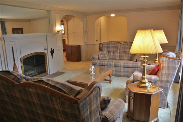 445 Falmouth Road Barnstable, MA 02601 - Photo 14 of 29 a living room with furniture and a fireplace
