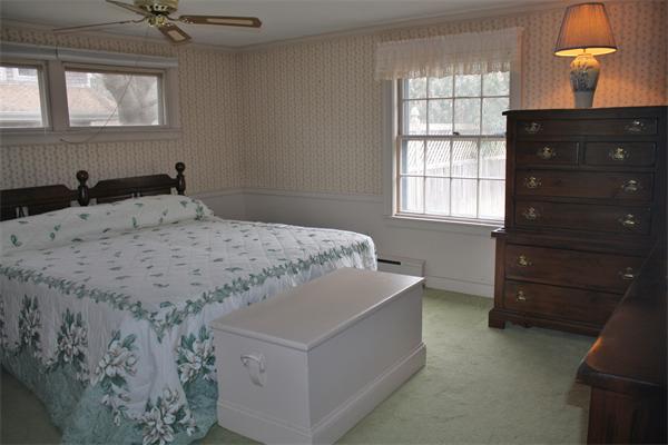 445 Falmouth Road Barnstable, MA 02601 - Photo 24 of 29 a bedroom with a bed and window with lamp