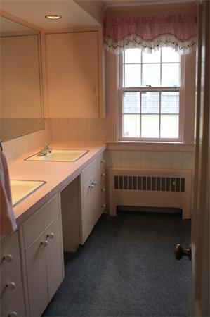 445 Falmouth Road Barnstable, MA 02601 - Photo 25 of 29 a bathroom with a double vanity sink a mirror and a bathtub
