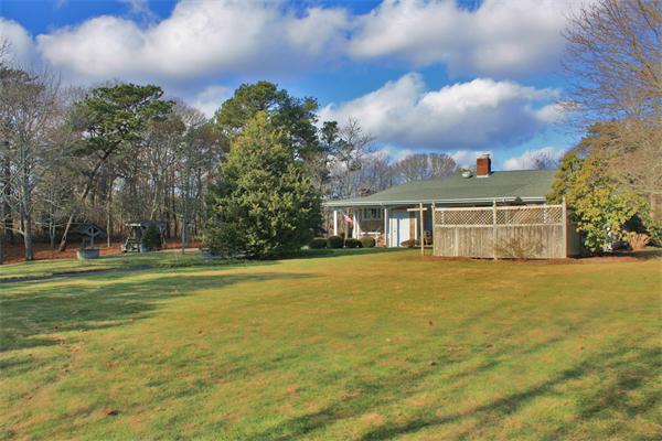 445 Falmouth Road Barnstable, MA 02601 - Photo 3 of 29 a front view of a house with a garden