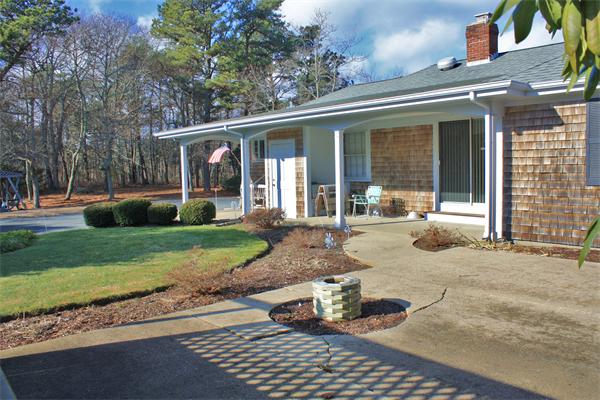 445 Falmouth Road Barnstable, MA 02601 - Photo 4 of 29 a view of a house with a yard siting area and garden