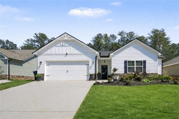 a front view of house with yard and green space