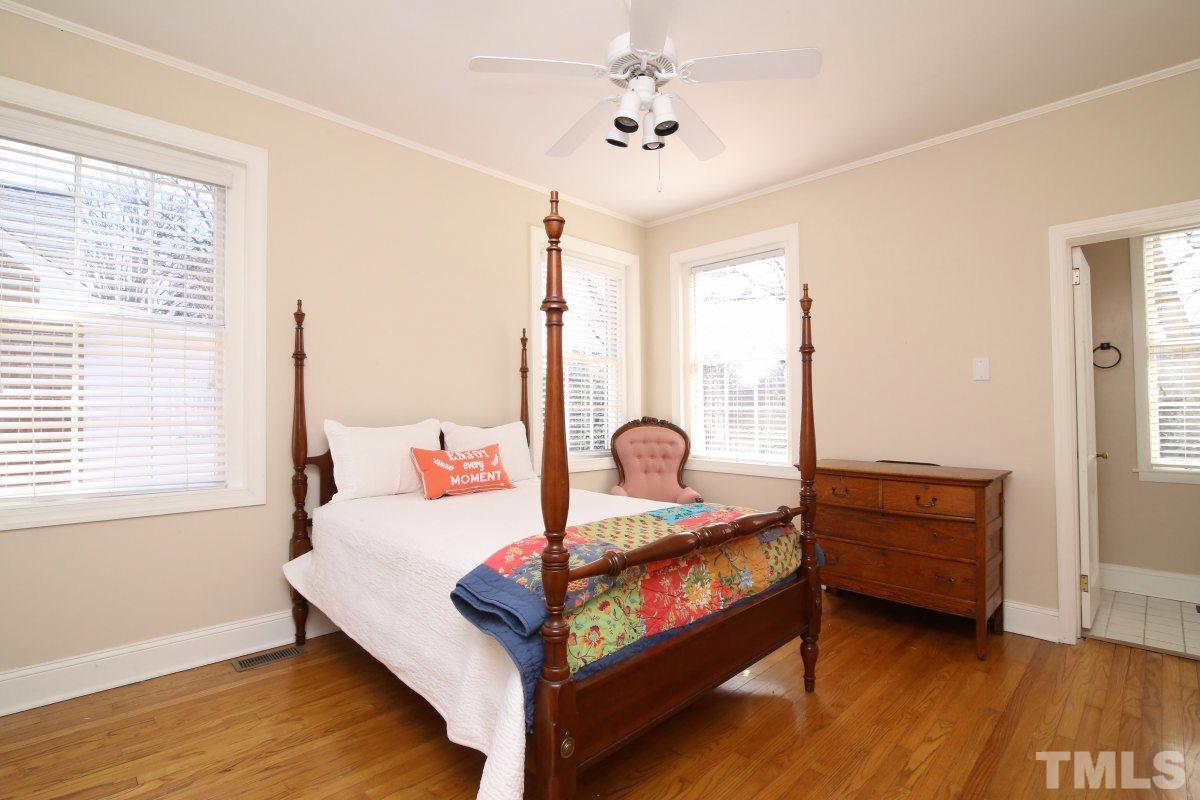 1011 Peace Street Raleigh, NC 27605 - Photo 11 of 25 a bedroom with a bed and wooden floor