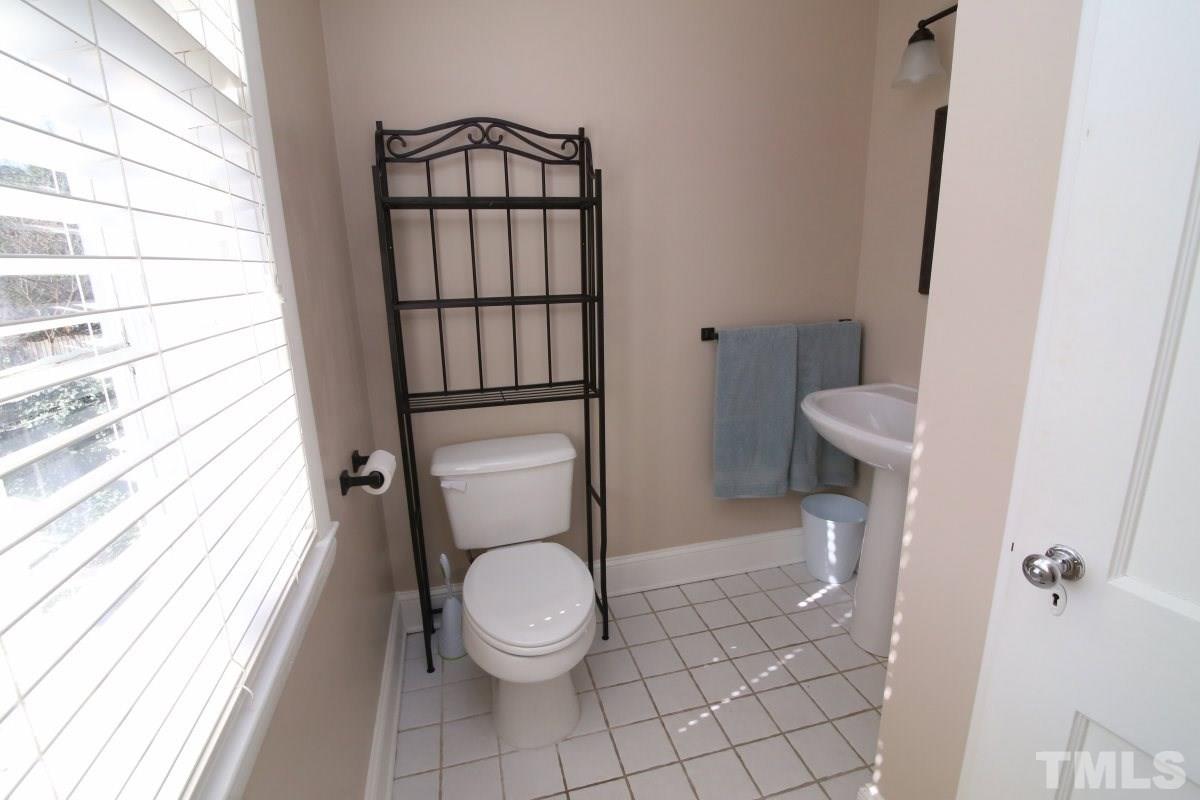1011 Peace Street Raleigh, NC 27605 - Photo 12 of 25 a white toilet sitting next to a small window