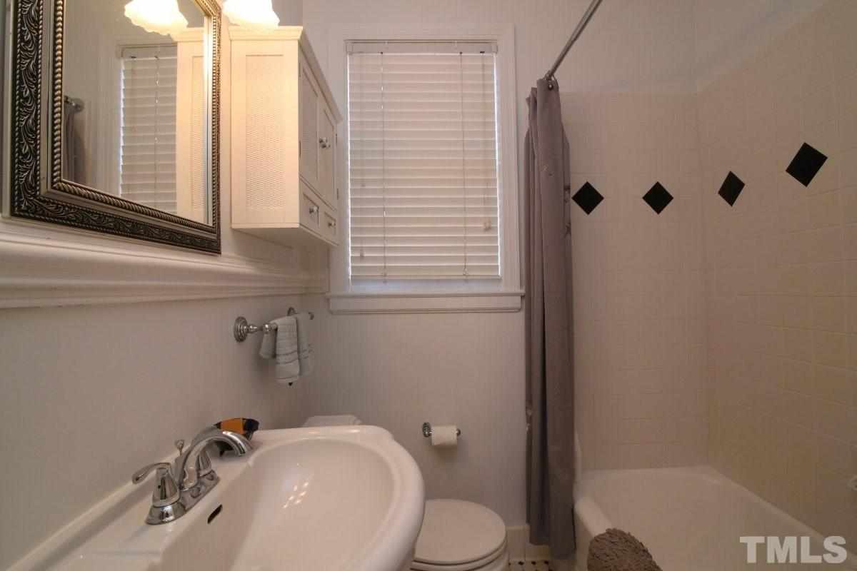 1011 Peace Street Raleigh, NC 27605 - Photo 14 of 25 a bathroom with a sink a toilet and shower