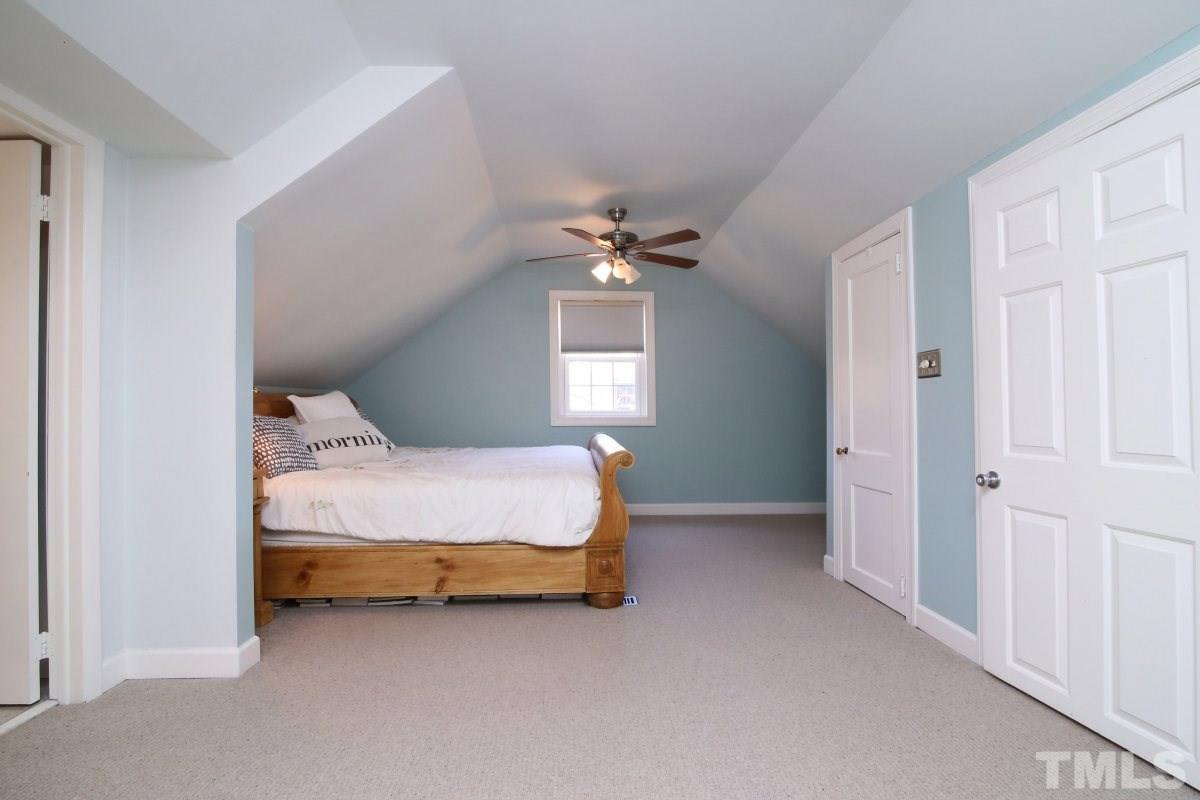 1011 Peace Street Raleigh, NC 27605 - Photo 15 of 25 a bed room with a bed and a chandelier