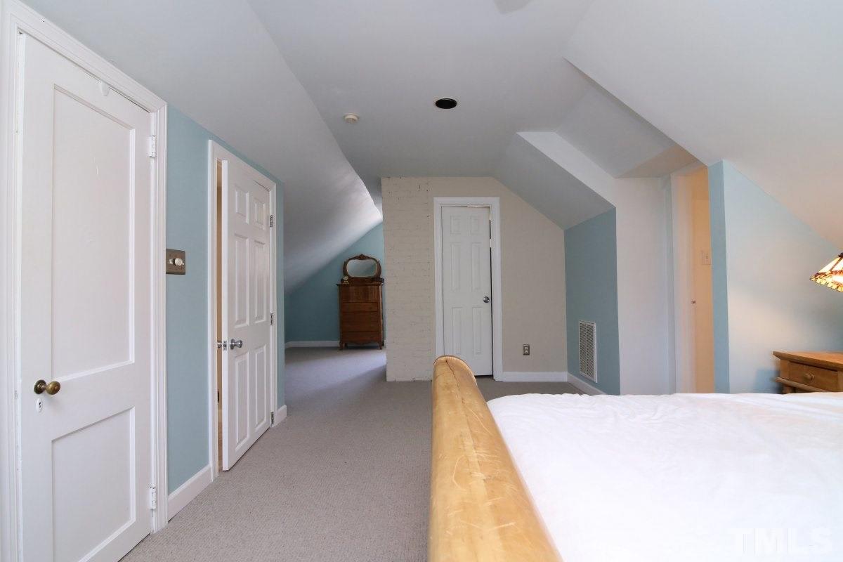 1011 Peace Street Raleigh, NC 27605 - Photo 16 of 25 a spacious bedroom with a bed and closet