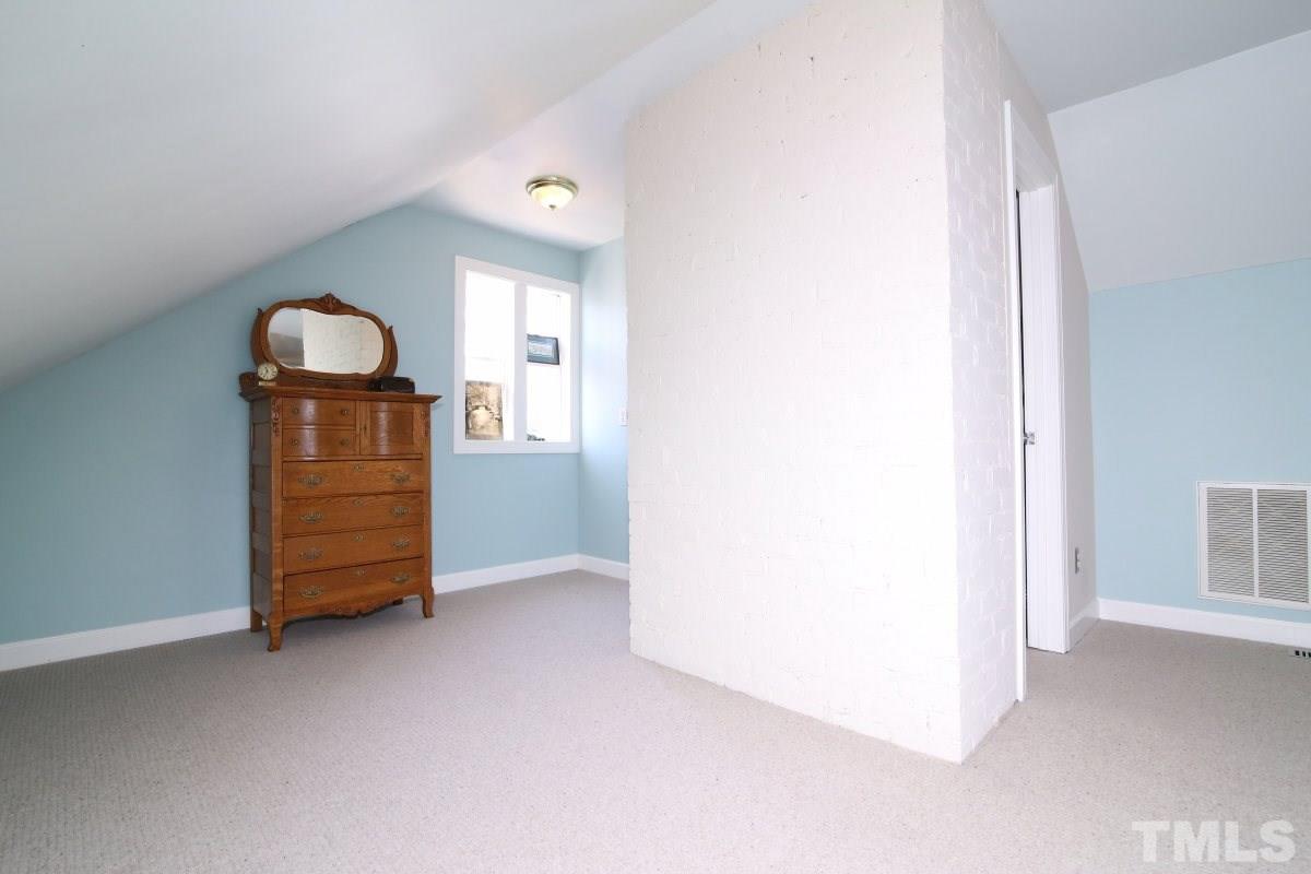 1011 Peace Street Raleigh, NC 27605 - Photo 17 of 25 a room with a dresser and a window
