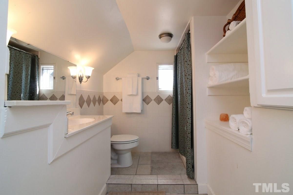 1011 Peace Street Raleigh, NC 27605 - Photo 19 of 25 a bathroom with a sink a toilet and shower