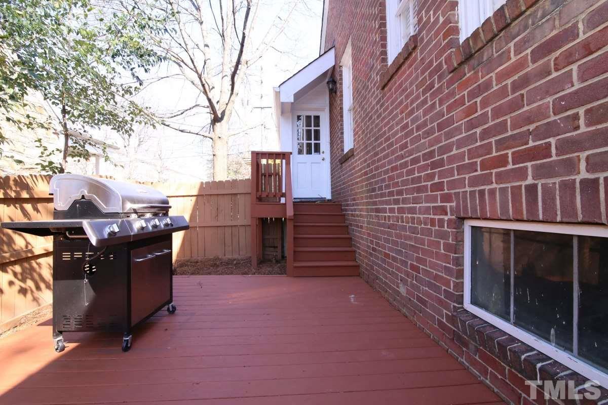 1011 Peace Street Raleigh, NC 27605 - Photo 23 of 25 a backyard of a house with barbeque oven and brick wall