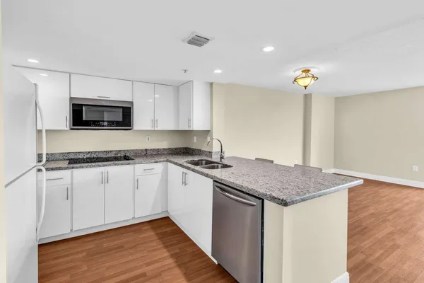 a kitchen that has a sink and a stove in it