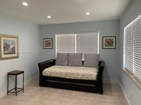 a bedroom with a bed and a chair
