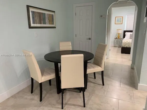 a view of a workspace with furniture and a bathroom