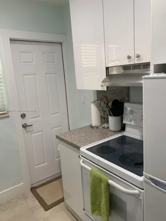 a kitchen with a sink and white cabinets