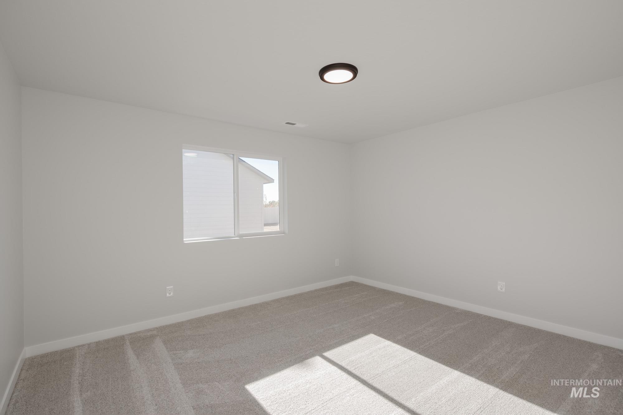 13723 Nisene Street Caldwell, ID 83607 - Photo 17 of 22 Empty room with light carpet and baseboards