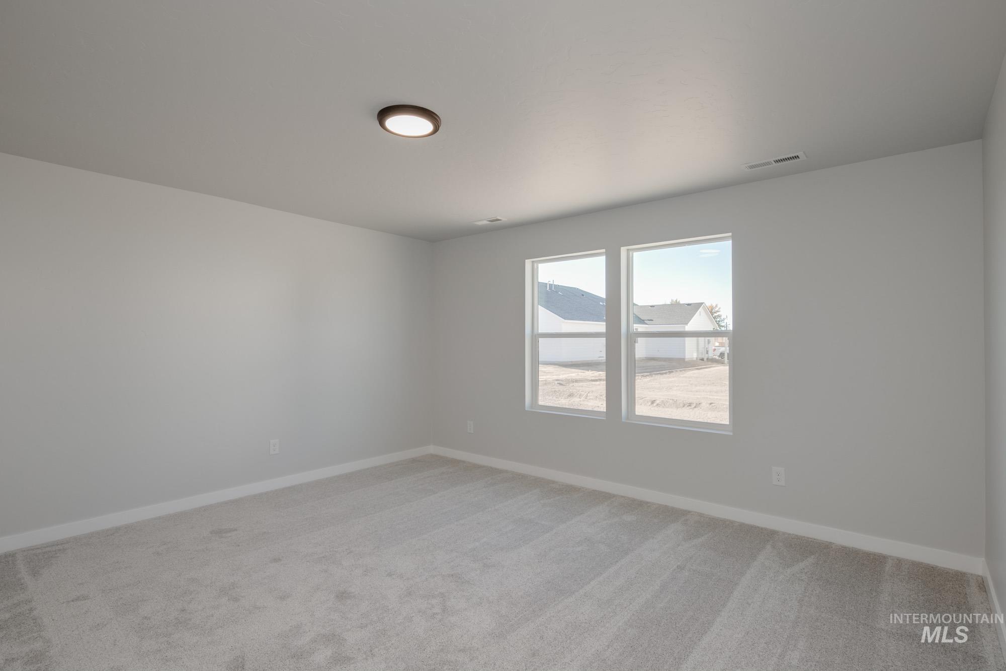 13723 Nisene Street Caldwell, ID 83607 - Photo 18 of 22 Spare room featuring baseboards and light colored carpet